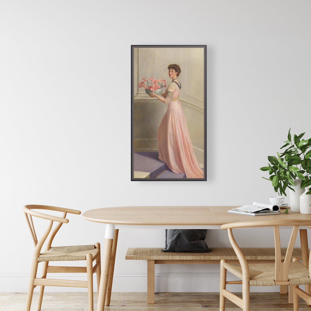 Portrait of a lady in pink carrying a bowl of pink carnations